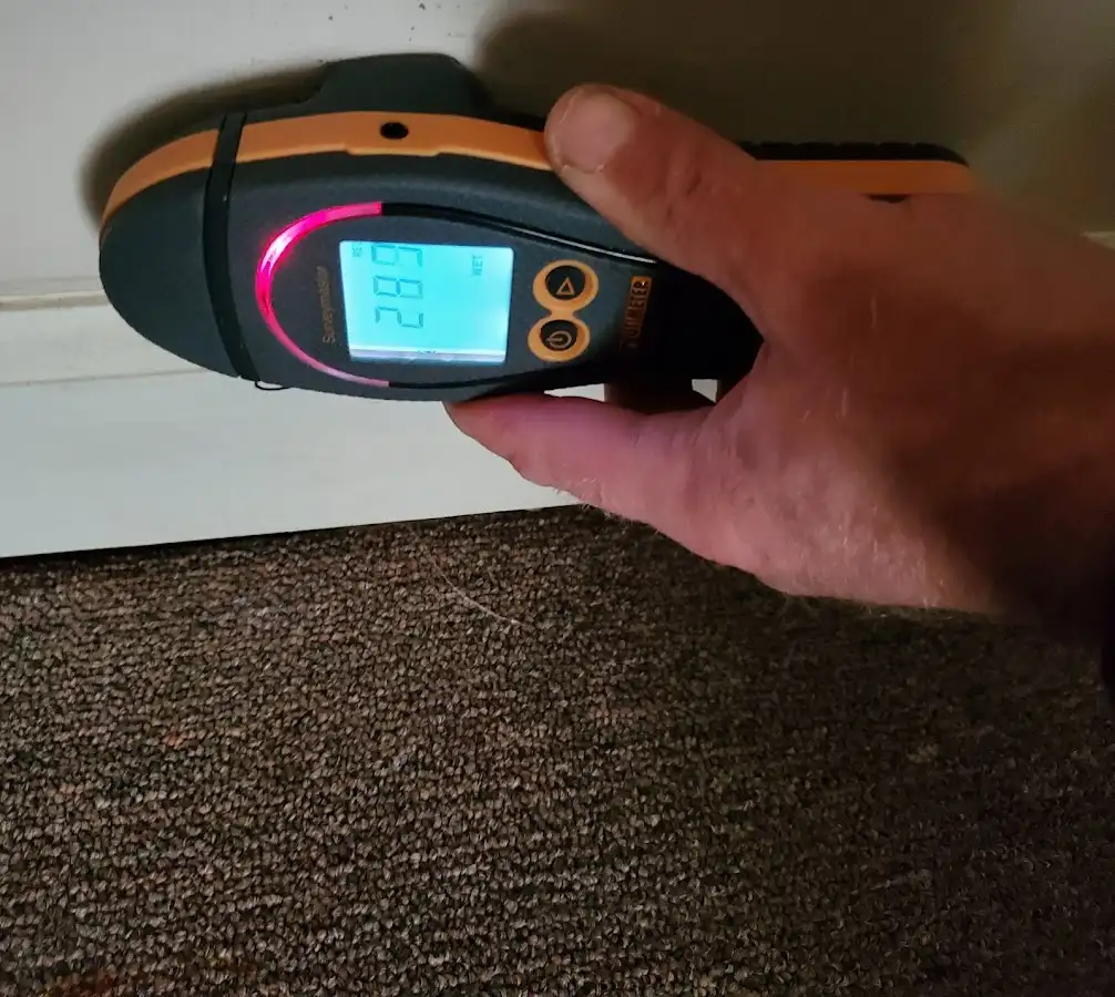 Moisture detection at baseboard during Storm Damage Restoration in Parker